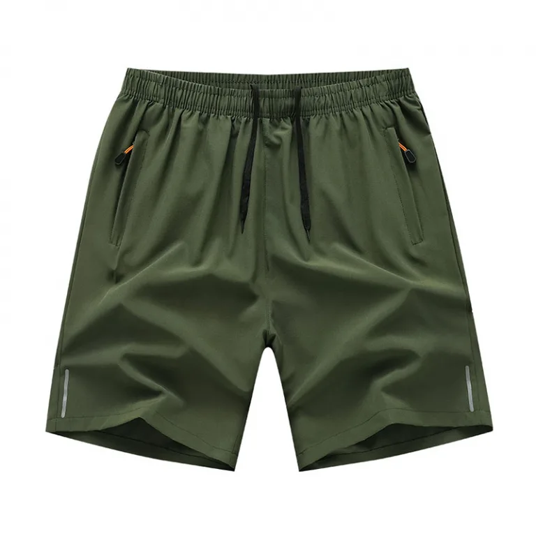Green athletic shorts with elastic waistband and zippered pockets.