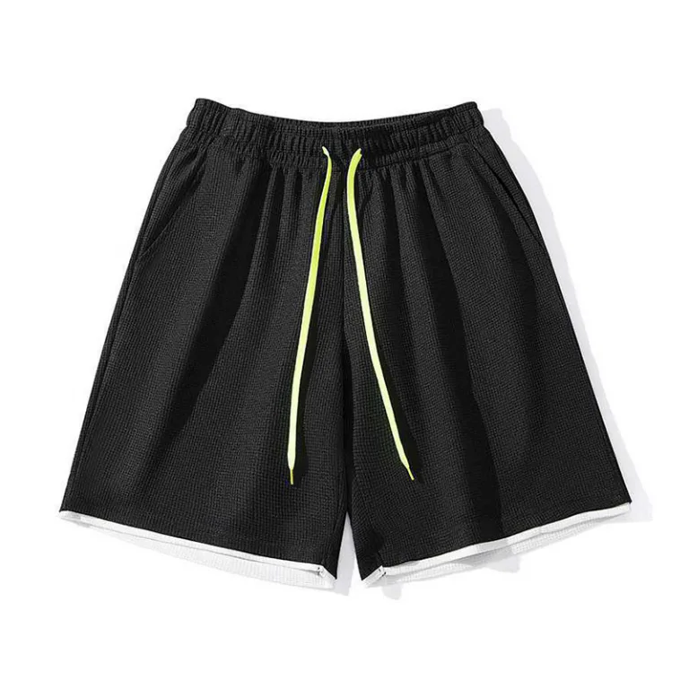 Black athletic shorts with yellow drawstring.