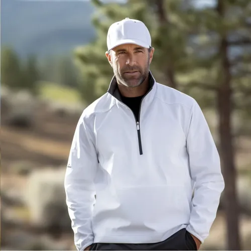 Golf Clothing 5 Man in white jacket and cap outdoors.