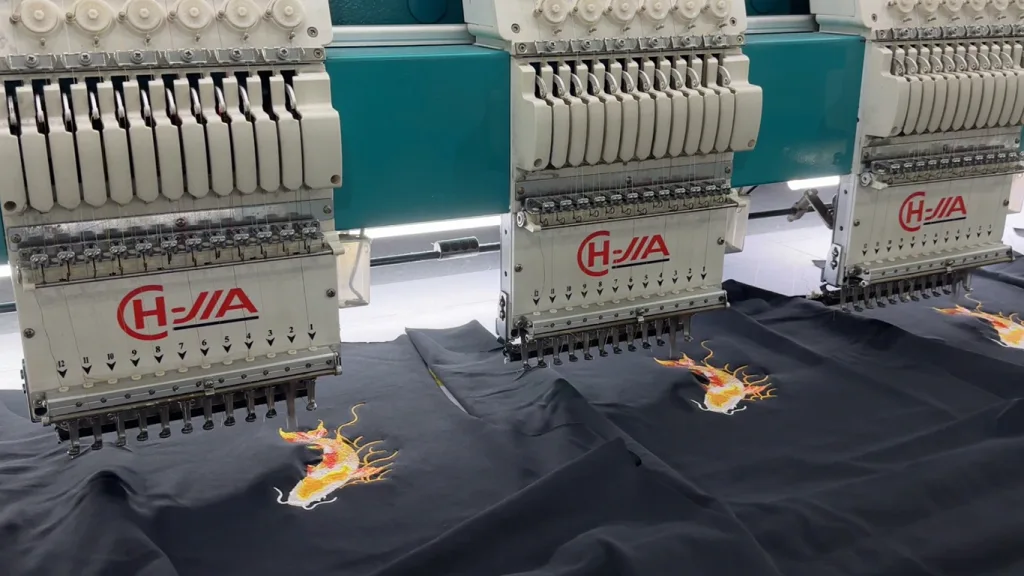 How to Customize Polo Shirts for Corporate Branding 3 Close-up of embroidery machine stitching logos onto polo shirts.