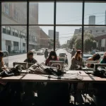 A hoodie design studio in downtown Los Angeles with fabric rolls and sewing machines.