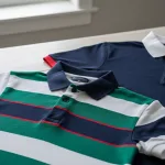 Striped and contrast polo shirts showing texture, stripes, and collar detail on a tabletop