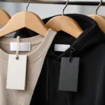 A close-up of apparel main labels and swing tags on private label clothing, highlighting branding details and quality.