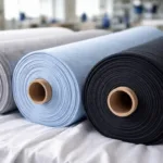 A clean view of cotton fabric rolls ready for t-shirt manufacturing, highlighting texture and process clarity.