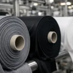 A clean, high-resolution image of performance swimwear fabric rolls showing their stretch and surface details, perfect for illustrating the best fabric for swimwear manufacturing.