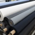 A close look at high-performance Dri-Fit fabric rolls with a technical, shop-floor feel, showing base materials used in custom shirt production.