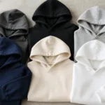 A selection of blank hoodies in various colors displayed for printing brands, highlighting material and construction for comparison.
