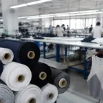 Shows a professional manufacturing environment with performance fabrics, highlighting running apparel sampling and material choices that fitness brands can adapt.