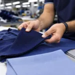 A professional sourcing scene showing fabric swatches used to compare polo constructions for corporate, golf, workwear, and promotional programs.